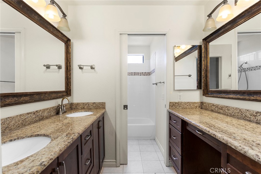 2881 Todd Street Oceanside, CA 92054 - Photo 28 of 41 a bathroom with a granite countertop sink and a mirror