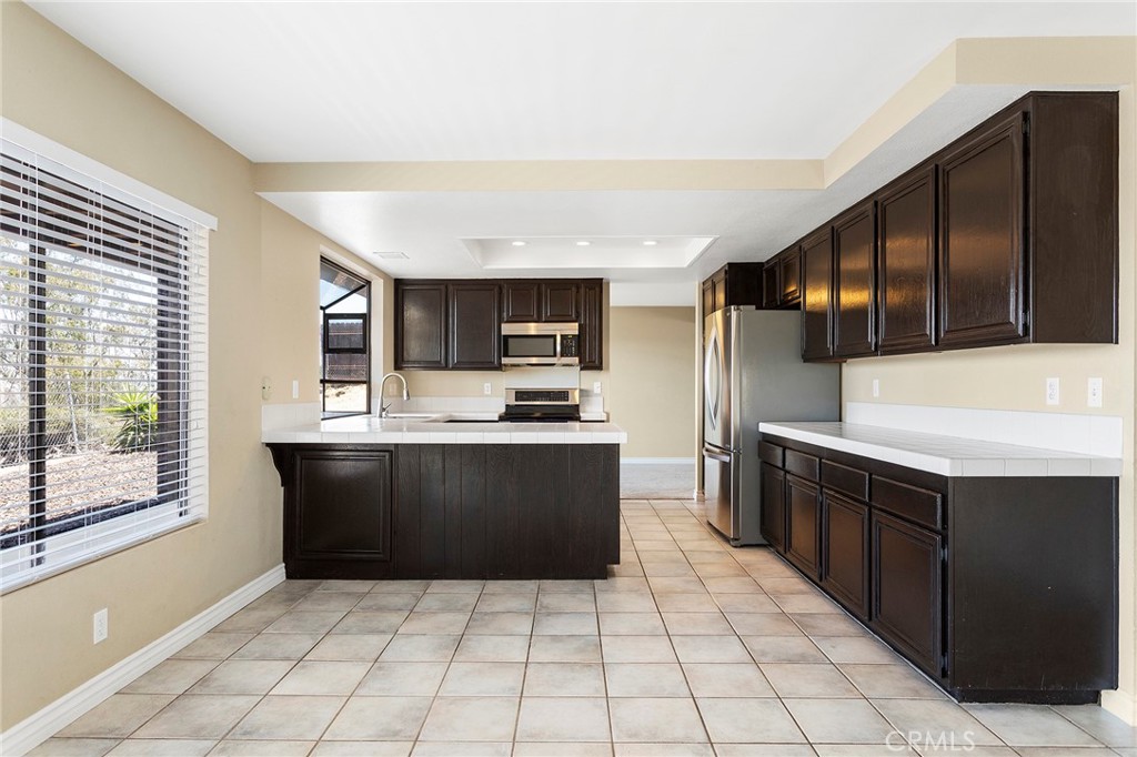 2881 Todd Street Oceanside, CA 92054 - Photo 9 of 41 a kitchen with stainless steel appliances granite countertop a refrigerator and a stove top oven