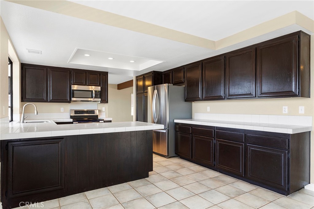 2881 Todd Street Oceanside, CA 92054 - Photo 10 of 41 a kitchen with stainless steel appliances a sink dishwasher stove top oven and refrigerator