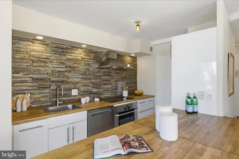 a kitchen with a sink and a stove