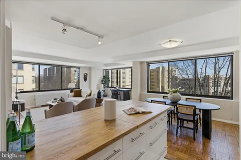 a view of a room with a large window and table