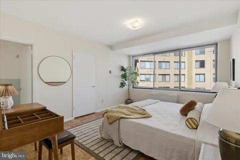 a bedroom with a bed and a couch