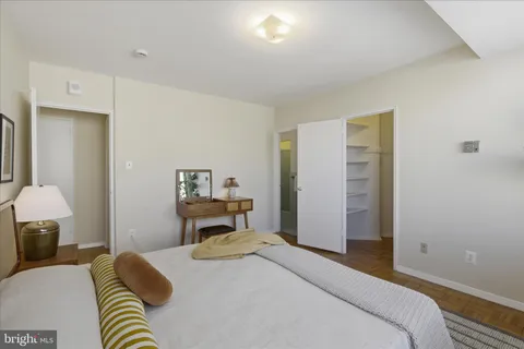a bedroom with a bed and a potted plant