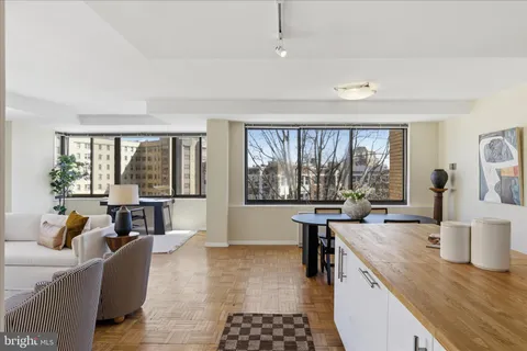 a living room with furniture and large windows