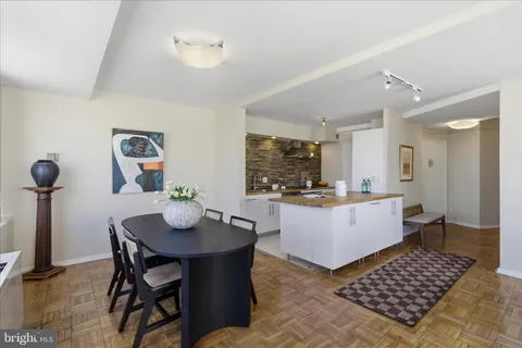 a kitchen with a dining table and chairs
