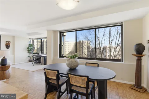a dining room with furniture and window