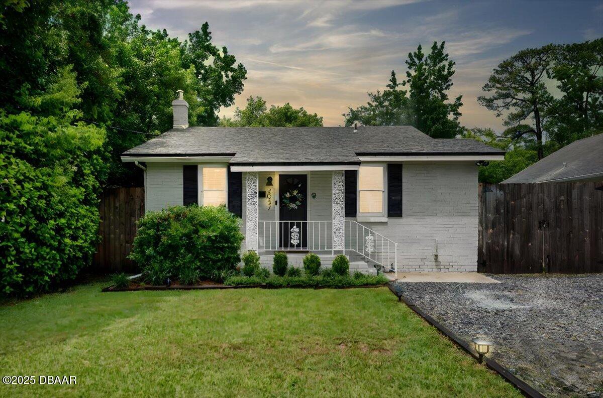 2057 Huntsford Road Jacksonville, FL 32207 - Photo 1 of 30 a view of a house with a yard plants and large tree