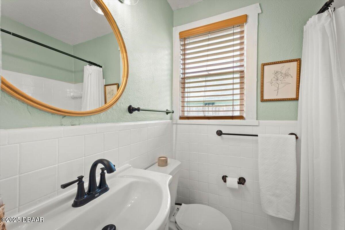 2057 Huntsford Road Jacksonville, FL 32207 - Photo 16 of 30 a bathroom with a sink and a mirror