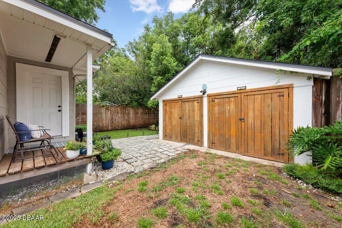 2057 Huntsford Road Jacksonville, FL 32207 - Photo 2 of 30 a backyard of a house with chairs and a fence