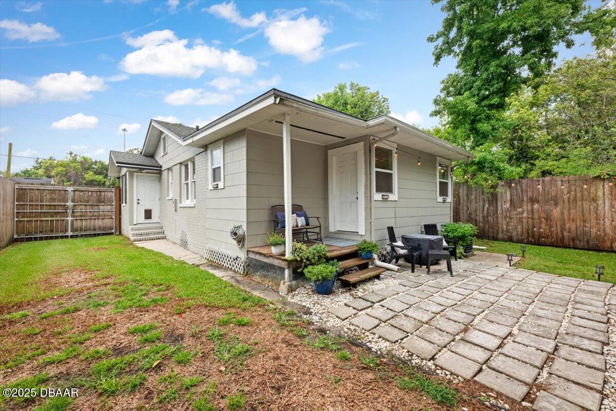 2057 Huntsford Road Jacksonville, FL 32207 - Photo 21 of 30 a view of backyard with table and chairs and wooden fence