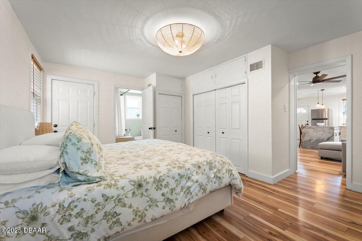 2057 Huntsford Road Jacksonville, FL 32207 - Photo 27 of 30 a bedroom with a large bed and a chandelier