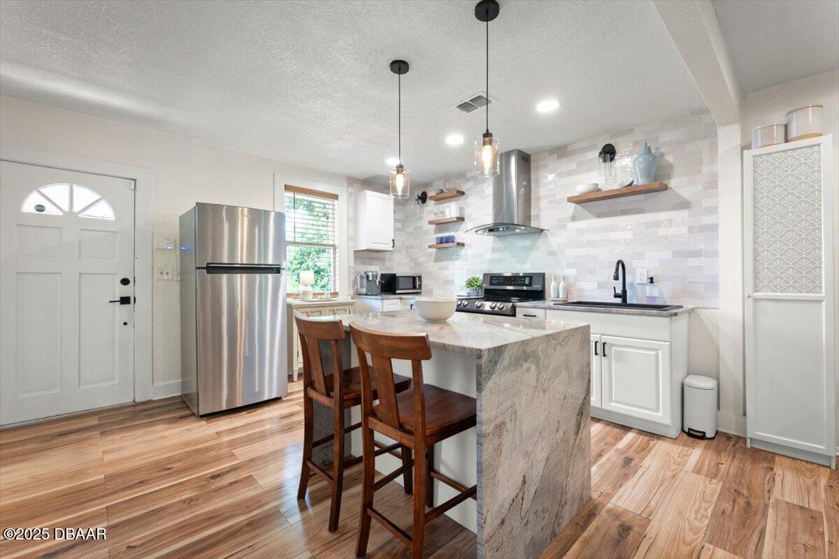 2057 Huntsford Road Jacksonville, FL 32207 - Photo 6 of 30 a kitchen with refrigerator a sink and chairs