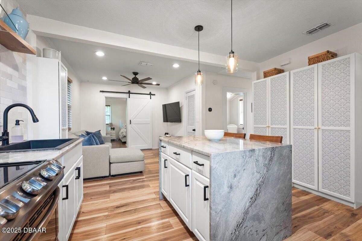 2057 Huntsford Road Jacksonville, FL 32207 - Photo 7 of 30 a large kitchen with a stove a sink dishwasher a refrigerator and a fireplace with wooden floor