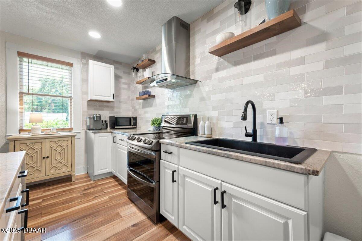 2057 Huntsford Road Jacksonville, FL 32207 - Photo 8 of 30 a kitchen with stainless steel appliances granite countertop a sink a stove and cabinets