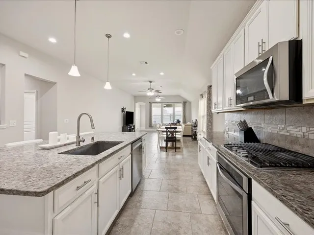 a spacious bedroom with a bed a window and walk in closet