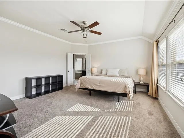 a spacious bedroom with a large bed and a window