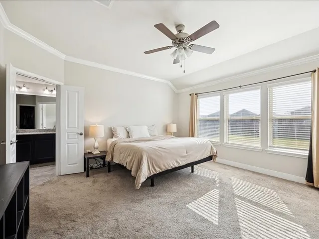 a bedroom with a bed outdoor view and a flat screen tv