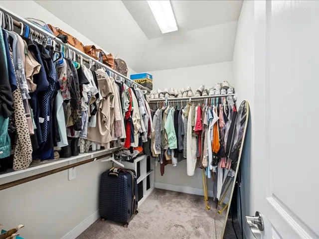 a living room with stainless steel appliances kitchen island granite countertop a sink and a flat screen tv