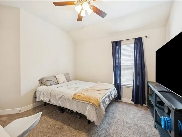 a bathroom with a granite countertop sink a toilet and a large mirror