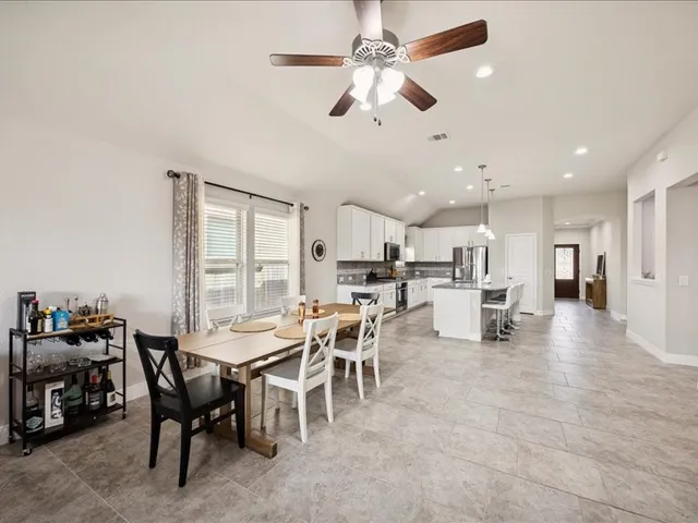 a large white kitchen with lots of counter space and appliances