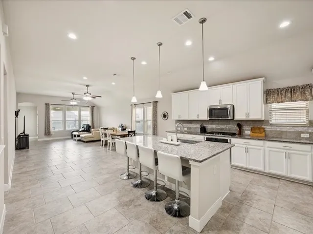 a kitchen with a sink a counter top space and stainless steel appliances