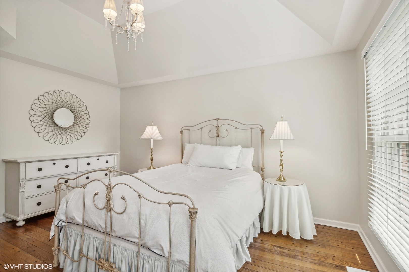 650 East Deerpath Road Lake Forest, IL 60045 - Photo 26 of 45 a bedroom with a bed and a chandelier