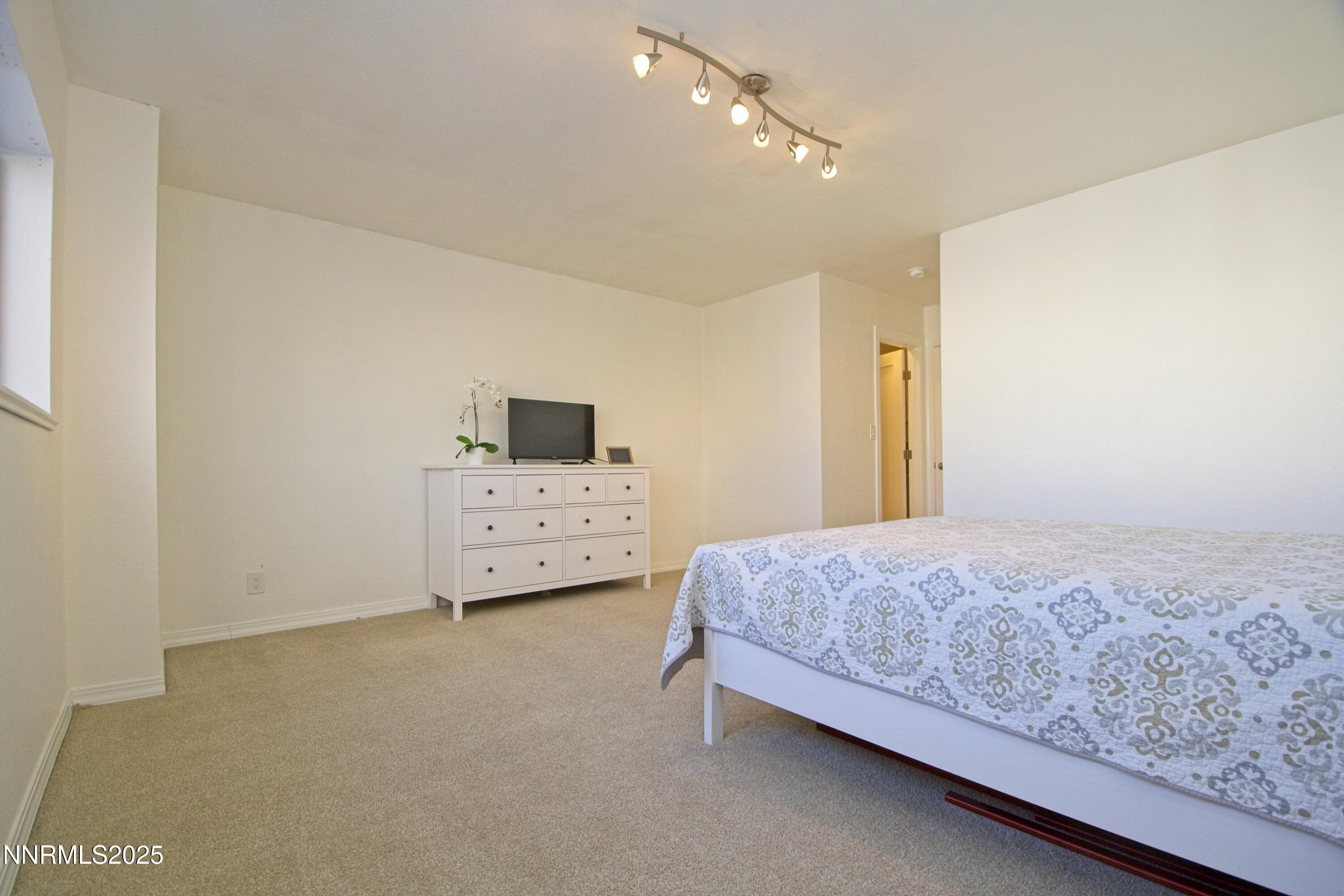 125 Mary Street, Unit A Reno, NV 89509 - Photo 13 of 22 a bedroom with a bed and a cabinets