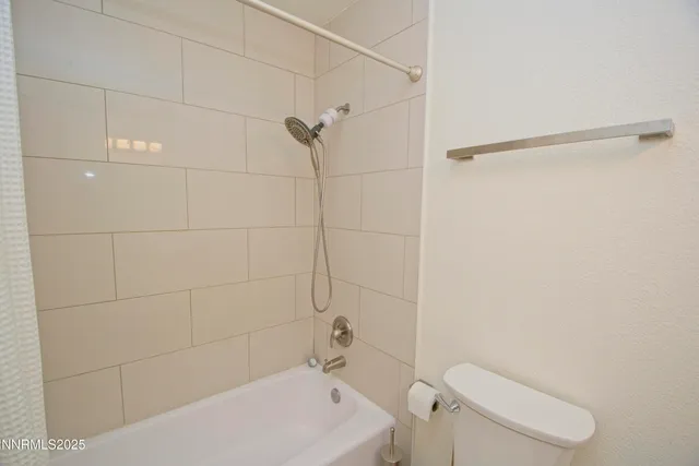 a bathroom with a shower and toilet