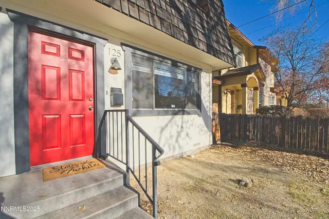 a view of a brick house with a small yard