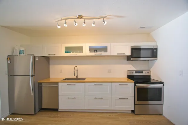 a kitchen with a refrigerator stove and microwave