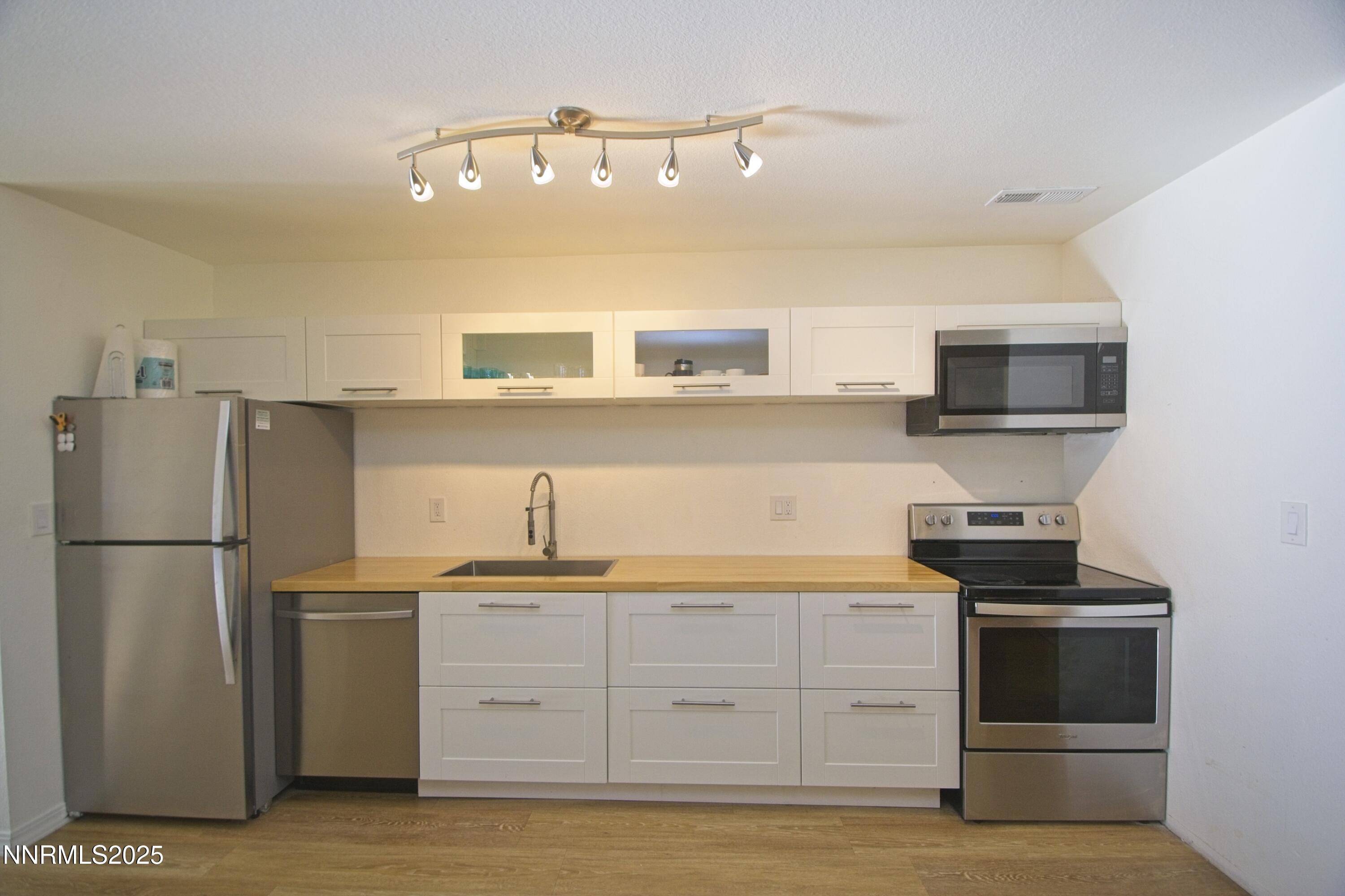 125 Mary Street, Unit A Reno, NV 89509 - Photo 9 of 22 a kitchen with a refrigerator stove and microwave