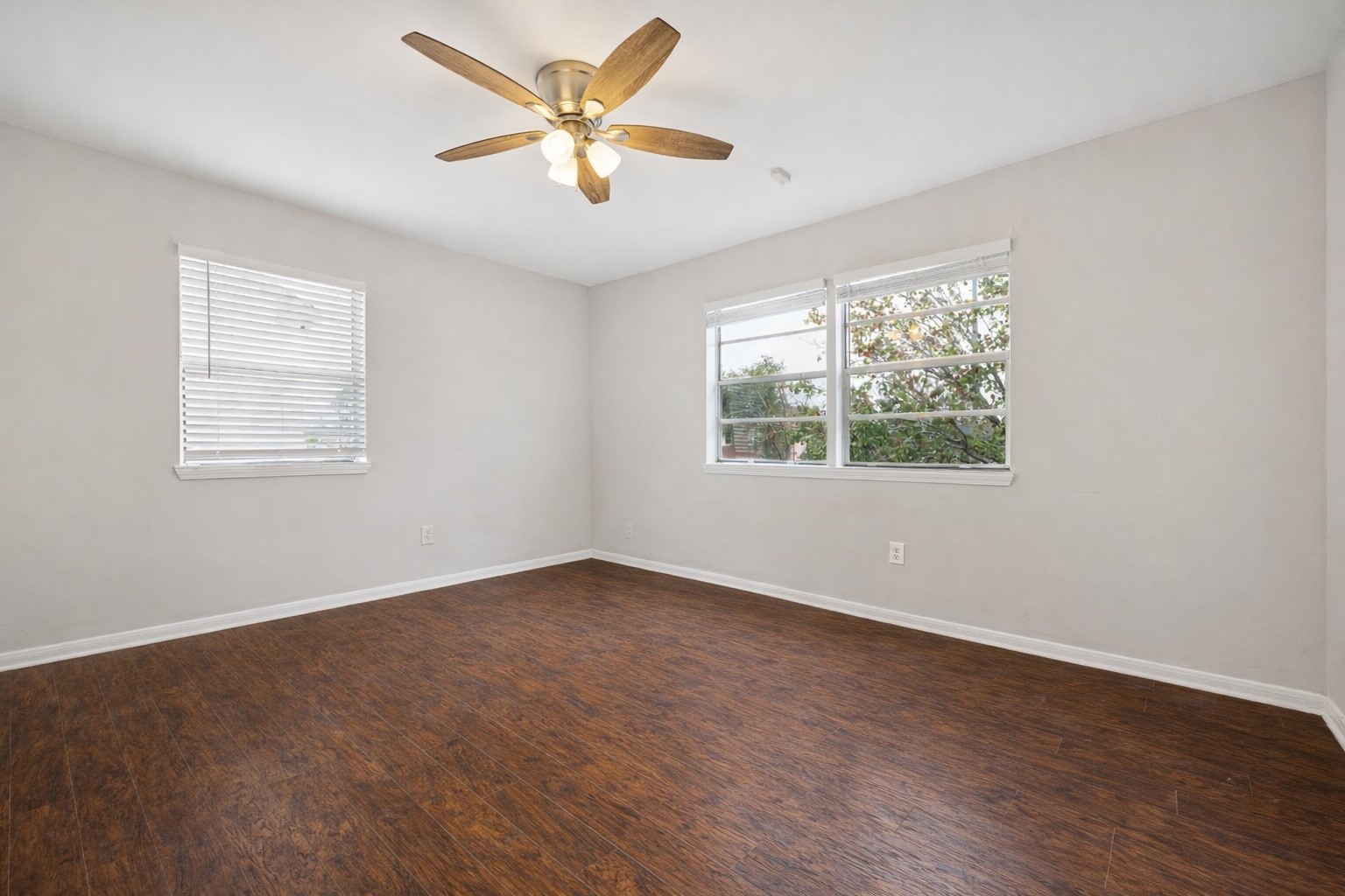 2614 Cleburne Street Houston, TX 77004 - Photo 13 of 22 A spacious, sun-drenched sanctuary. This primary bedroom welcomes an abundance of natural light throughout the day, mirroring the exact blueprint found in the downstairs unit.