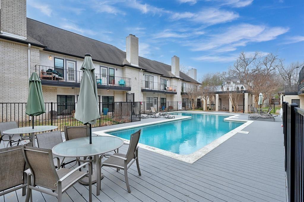 1307 Kinney Avenue, Unit 121 Austin, TX 78704 - Photo 1 of 12 a view of a patio with swimming pool table and chairs