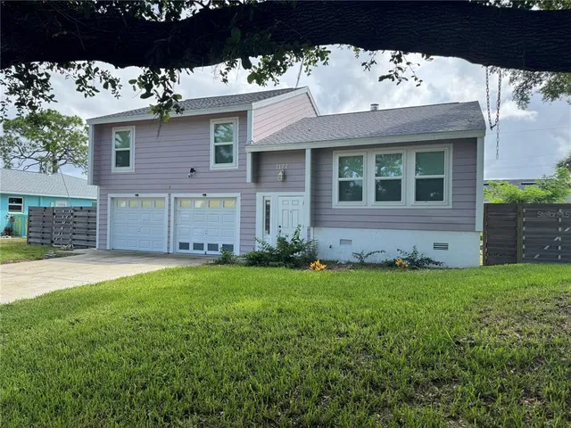 a view of a house with a garden and yard