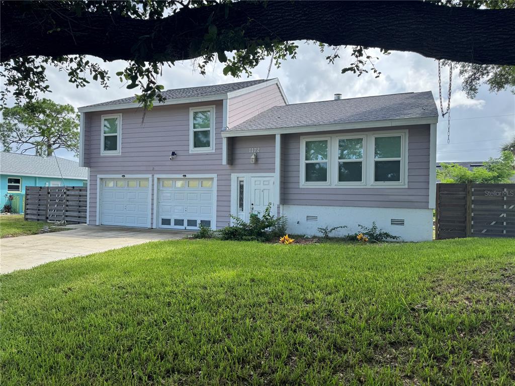 a view of a house with a garden and yard