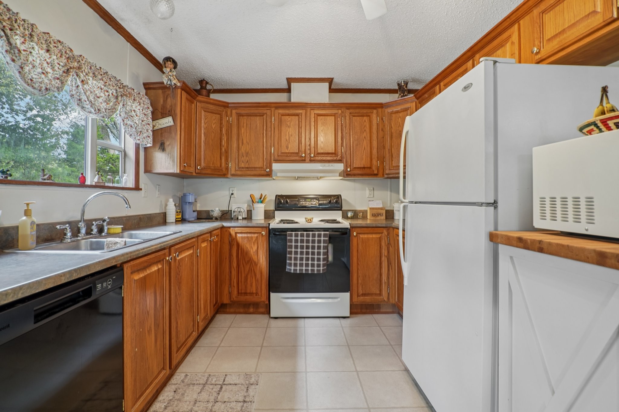 1765 Williamson Branch Road Vanleer, TN 37181 - Photo 19 of 59 a kitchen with stainless steel appliances granite countertop a refrigerator a sink dishwasher a stove with wooden cabinets