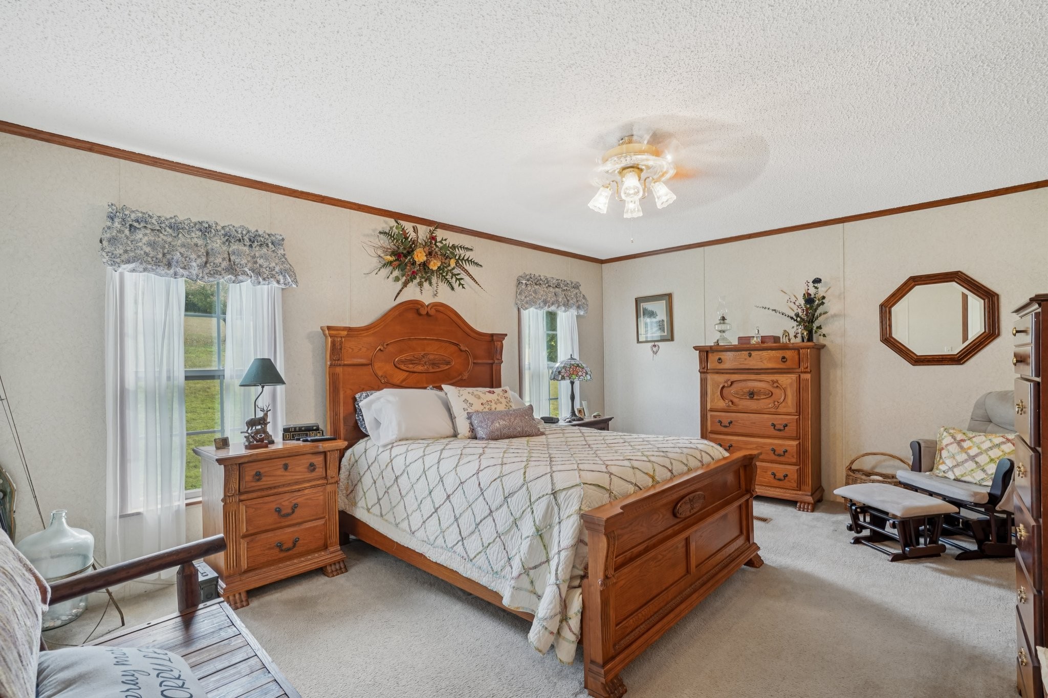 1765 Williamson Branch Road Vanleer, TN 37181 - Photo 21 of 59 a bedroom with a bed a couch and a painting on the wall