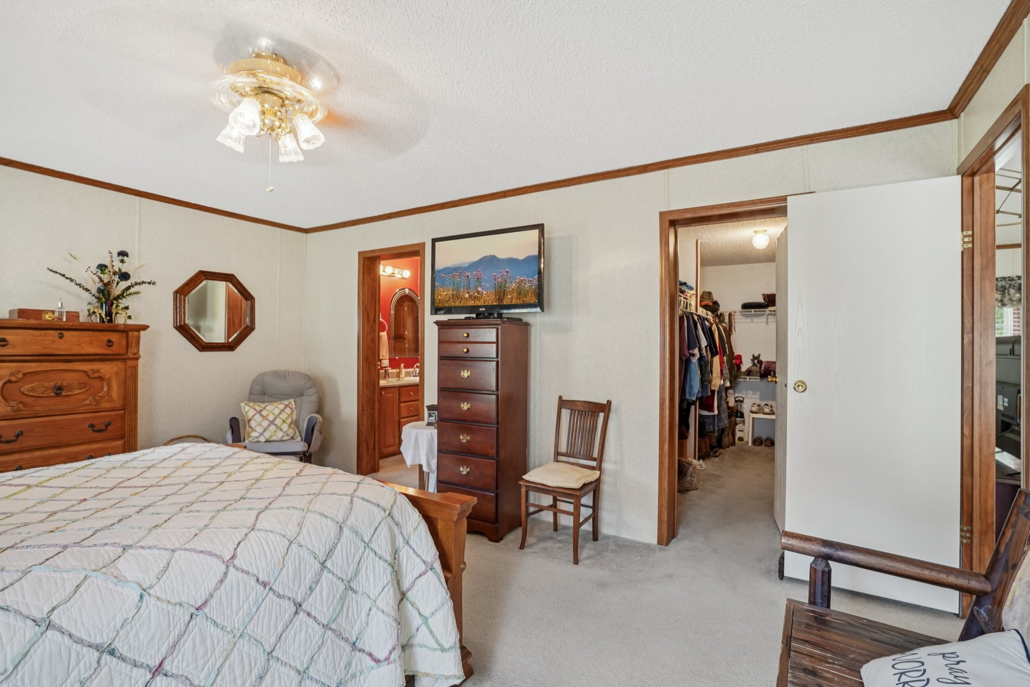 1765 Williamson Branch Road Vanleer, TN 37181 - Photo 22 of 59 a bedroom with a bed and a chandelier