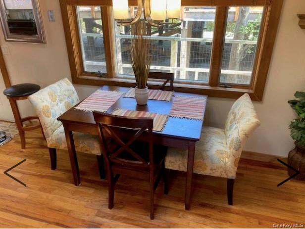151 Ocean Road Ocean Beach, NY 11770 - Photo 11 of 19 a dining room with furniture and wooden floor