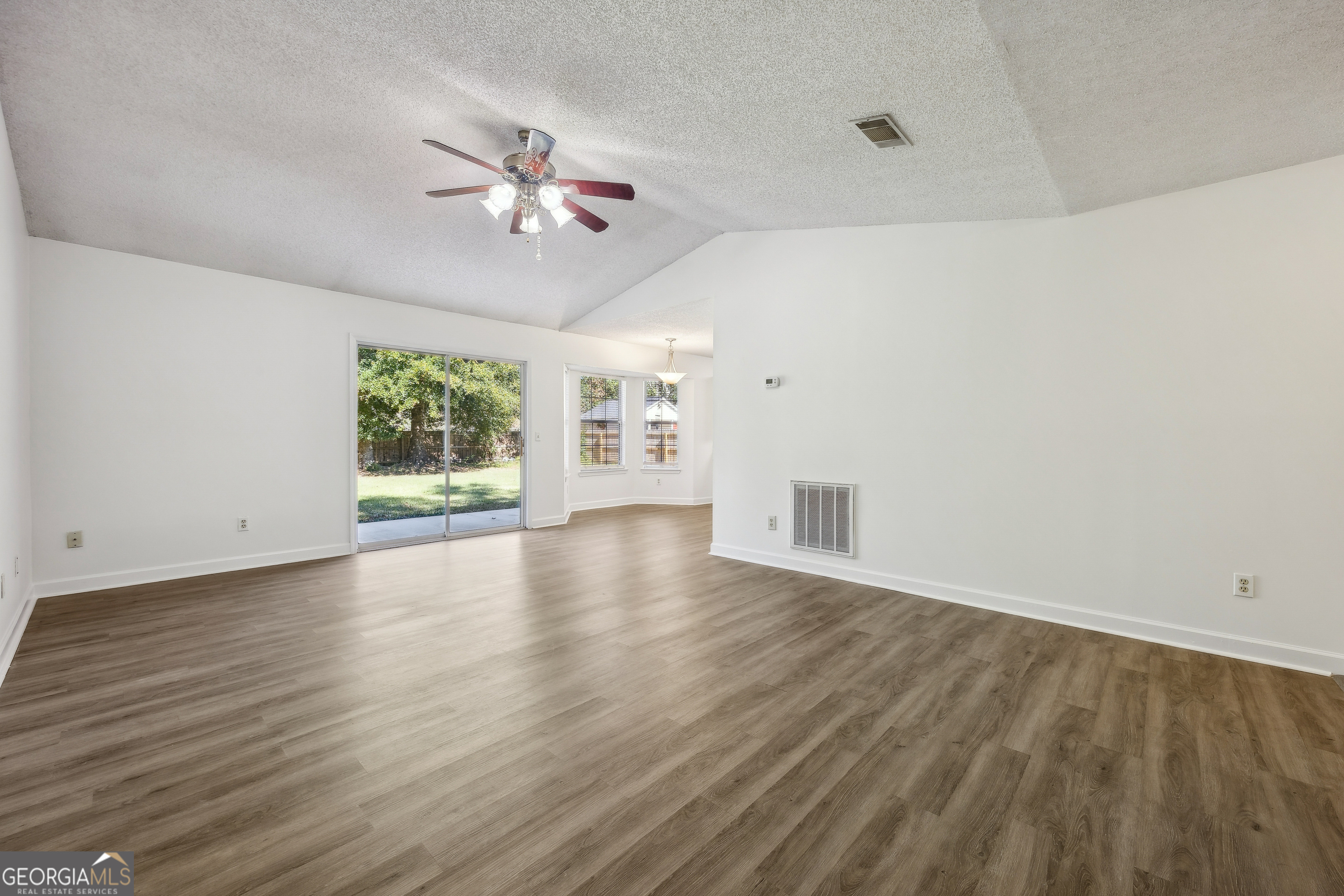 114 Colony Pines Drive Kingsland, GA 31548 - Photo 11 of 47 wooden floor in an empty room with a window