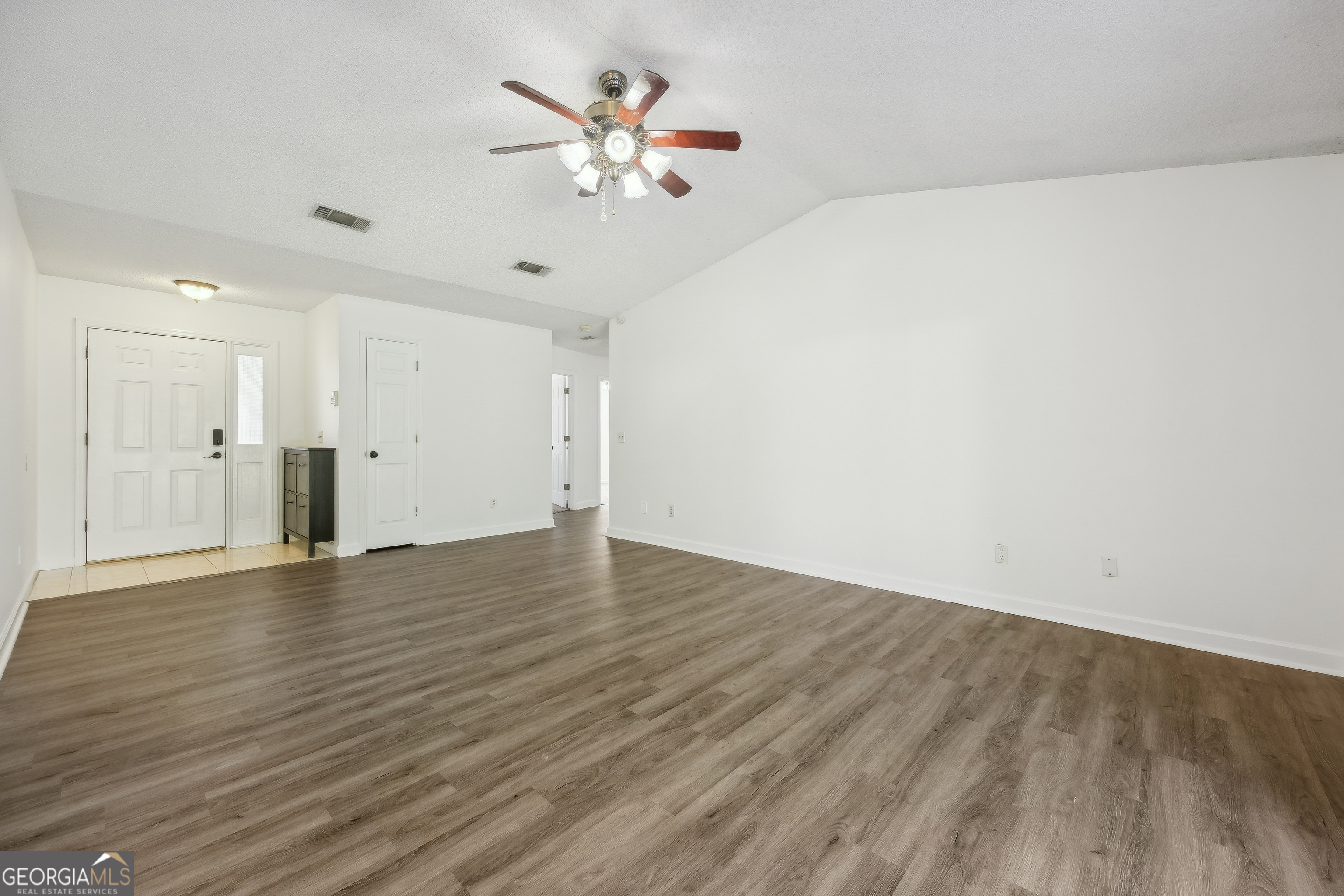114 Colony Pines Drive Kingsland, GA 31548 - Photo 13 of 47 a view of an empty room with wooden floor