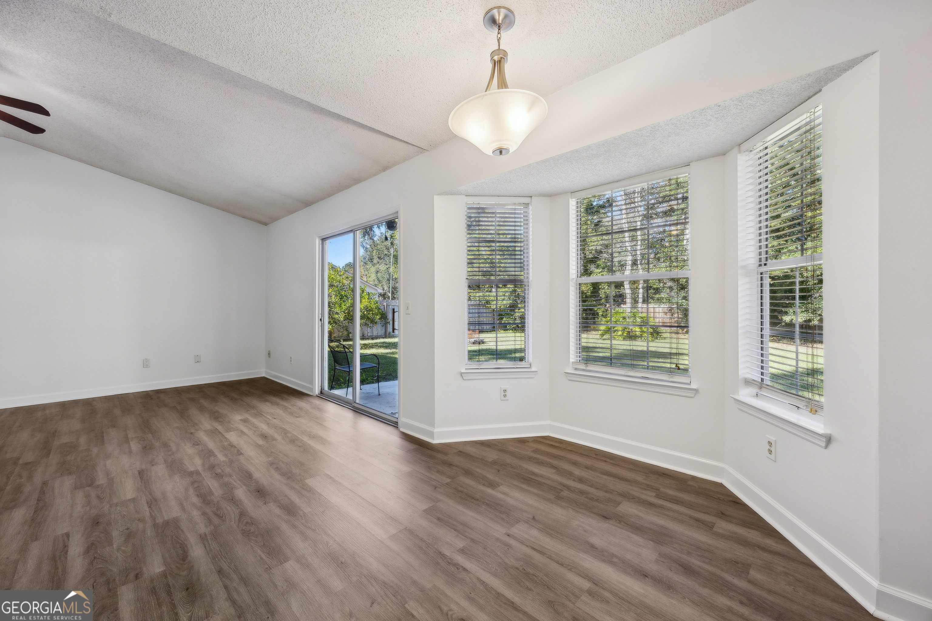 114 Colony Pines Drive Kingsland, GA 31548 - Photo 15 of 47 a view of an empty room with wooden floor and a window