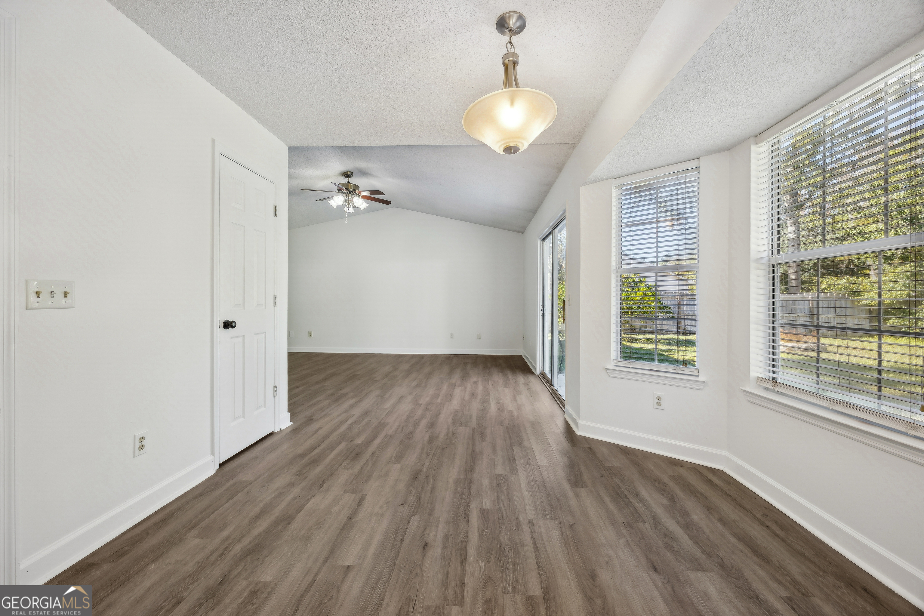 114 Colony Pines Drive Kingsland, GA 31548 - Photo 17 of 47 an empty room with wooden floor and windows