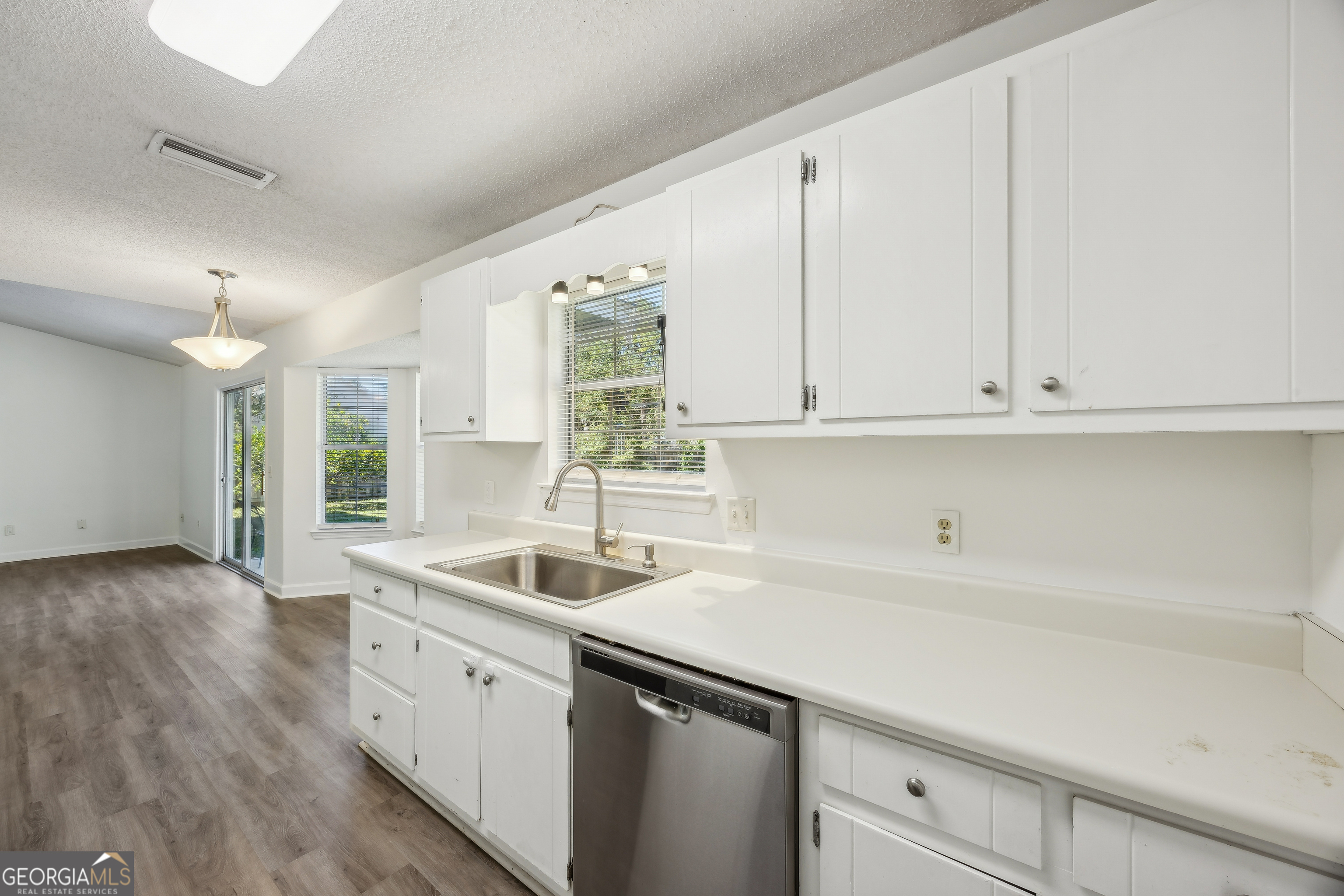 114 Colony Pines Drive Kingsland, GA 31548 - Photo 21 of 47 a kitchen that has a sink and cabinets with wooden floor