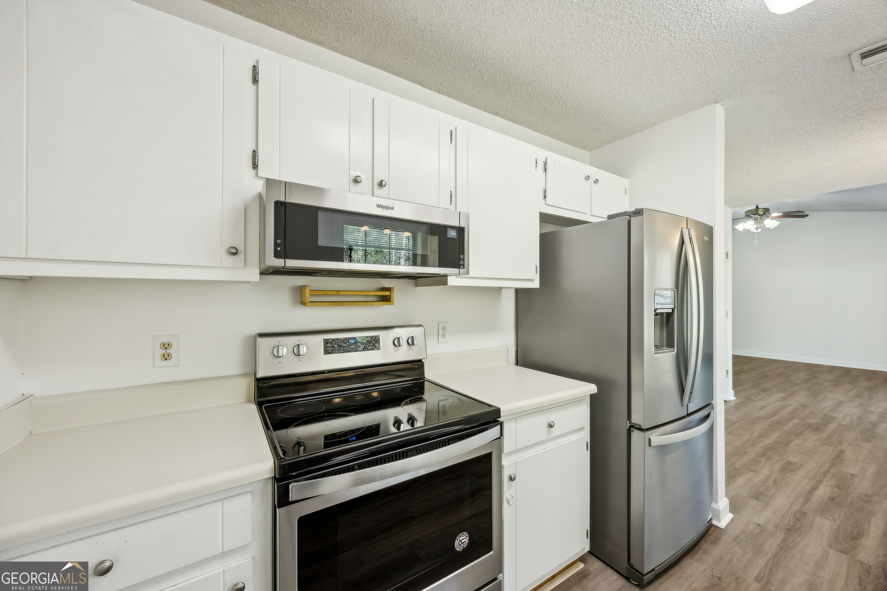 114 Colony Pines Drive Kingsland, GA 31548 - Photo 22 of 47 a kitchen with stainless steel appliances a refrigerator a stove and white cabinets