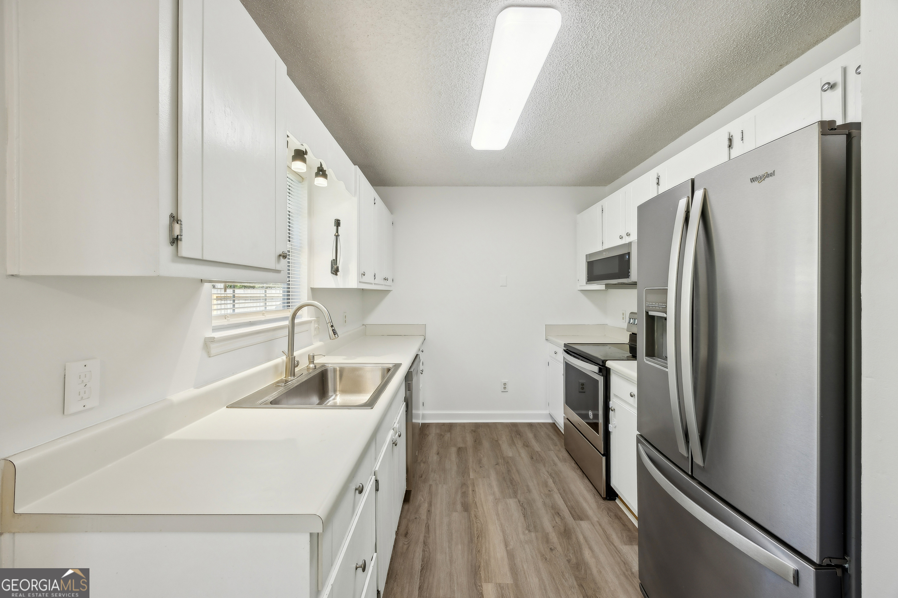 114 Colony Pines Drive Kingsland, GA 31548 - Photo 23 of 47 a kitchen with a refrigerator sink and stove