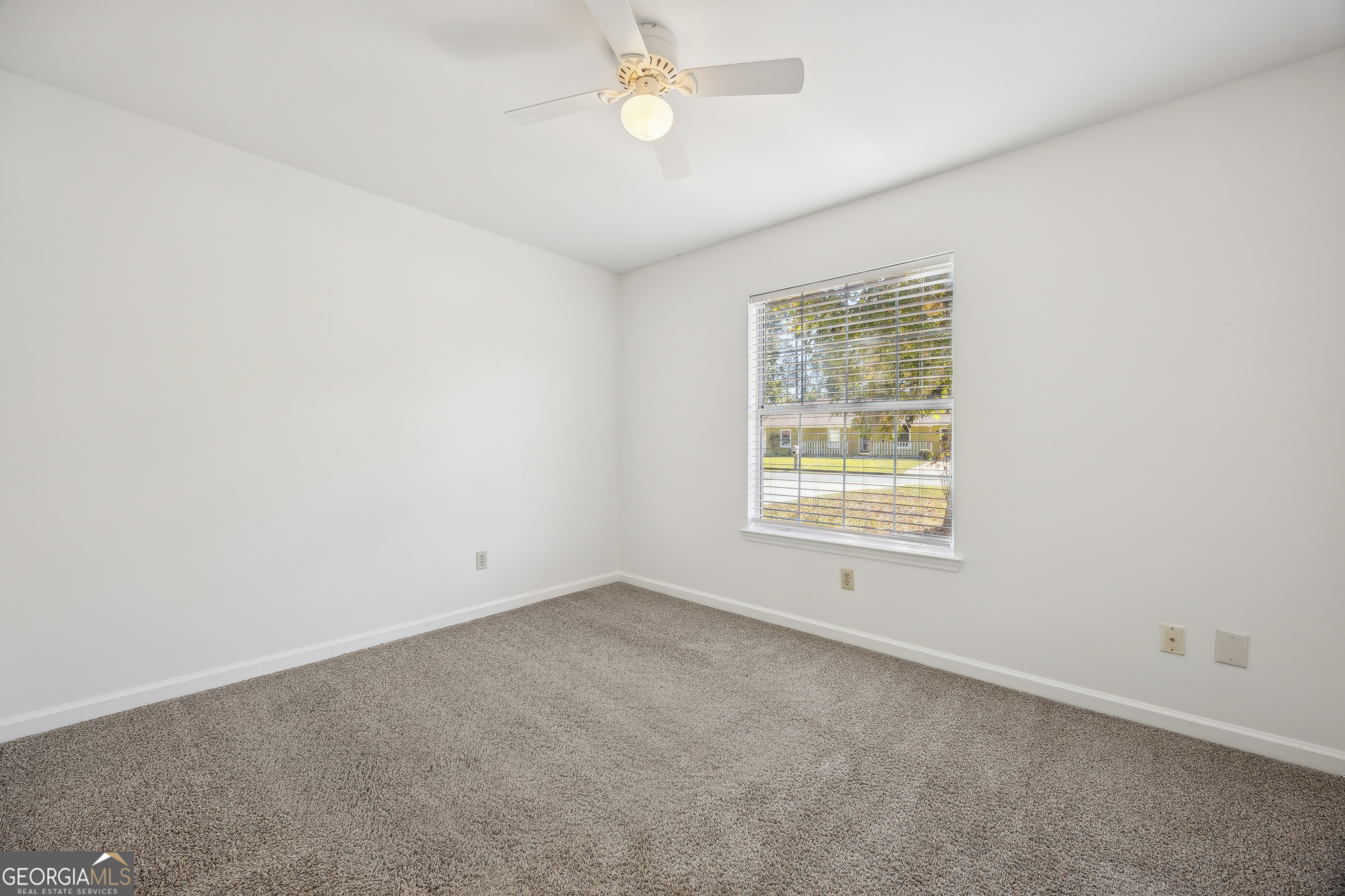 114 Colony Pines Drive Kingsland, GA 31548 - Photo 31 of 47 an empty room with a window and ceiling fan
