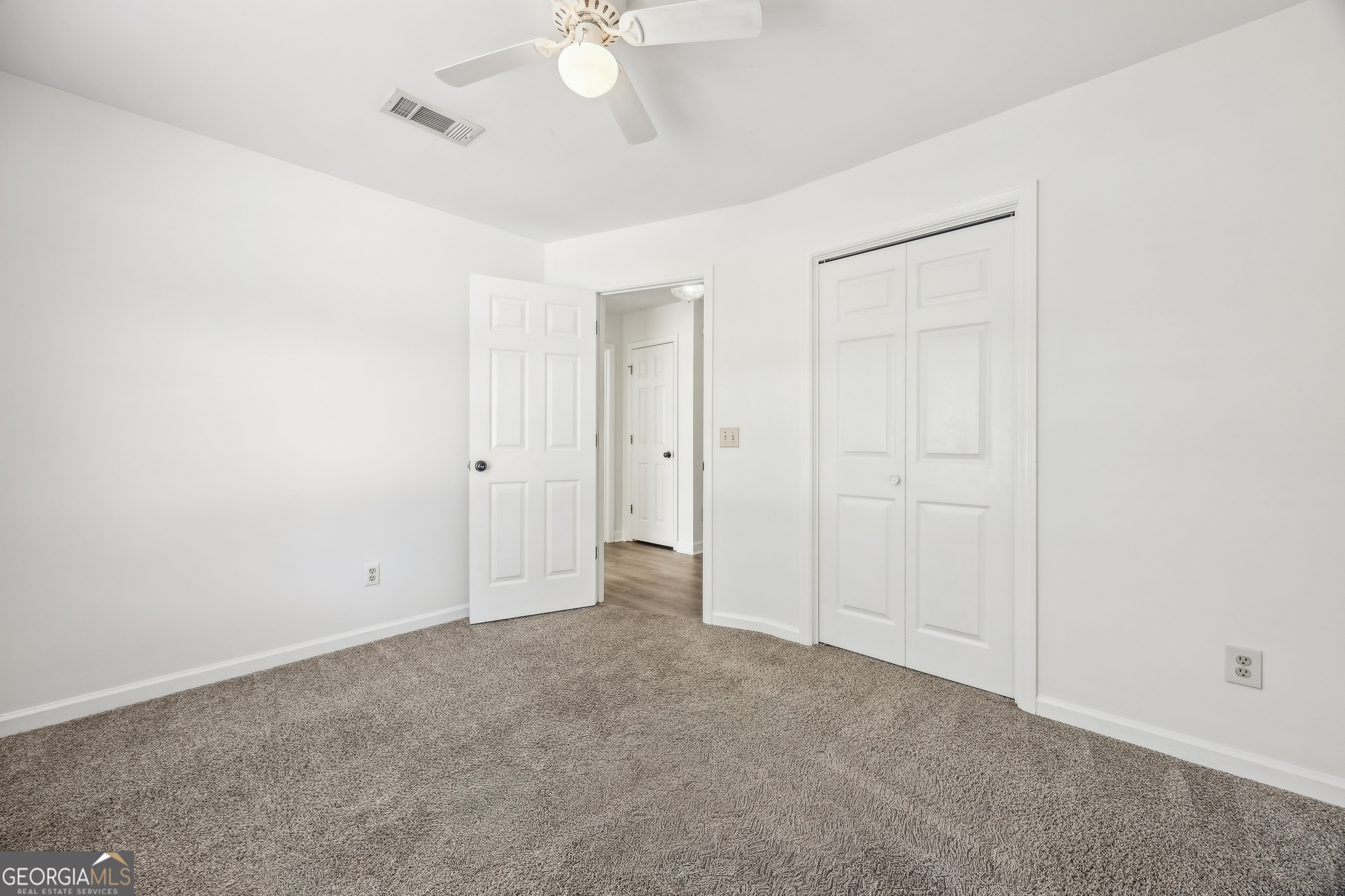114 Colony Pines Drive Kingsland, GA 31548 - Photo 32 of 47 an empty room with a ceiling fan and a window