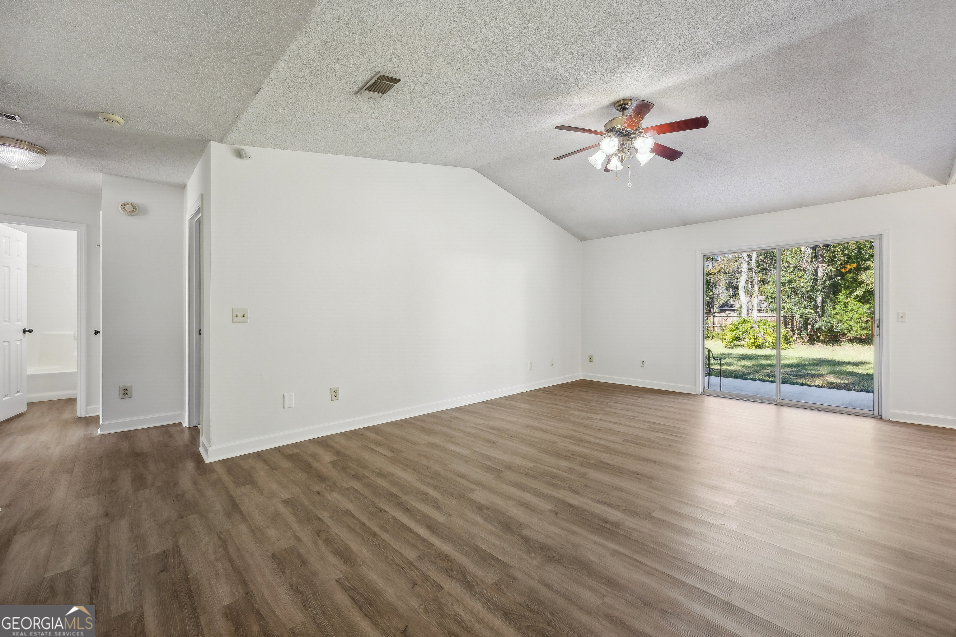 114 Colony Pines Drive Kingsland, GA 31548 - Photo 10 of 47 an empty room with wooden floor and windows