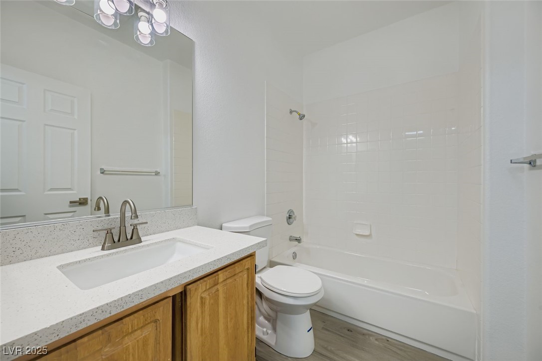 4941 Black Bear Road, Unit 203 Las Vegas, NV 89149 - Photo 11 of 11 Full bath with light wood-style floors, vanity, and shower combination